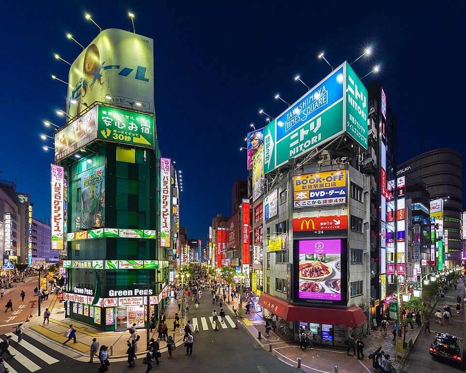 Buildings with colorful neon street signs at blue hour, Shinjuku, Tokyo.jpg — Basile Morin (CC BY-SA 4.0) Instagram Pink