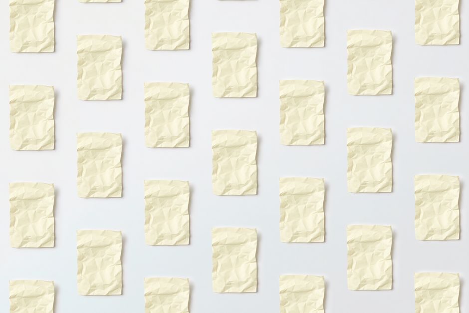 吉量 — Flat lay of crumpled paper sheets on a white background, creating an artistic pattern.