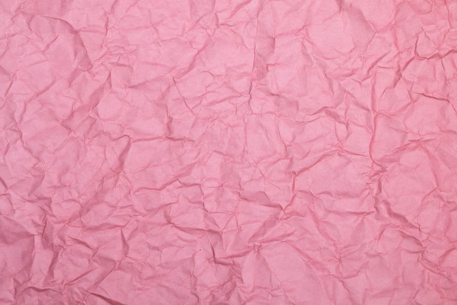 龙膏烛 — High-resolution close-up of a wrinkled pink paper texture, ideal for design use.