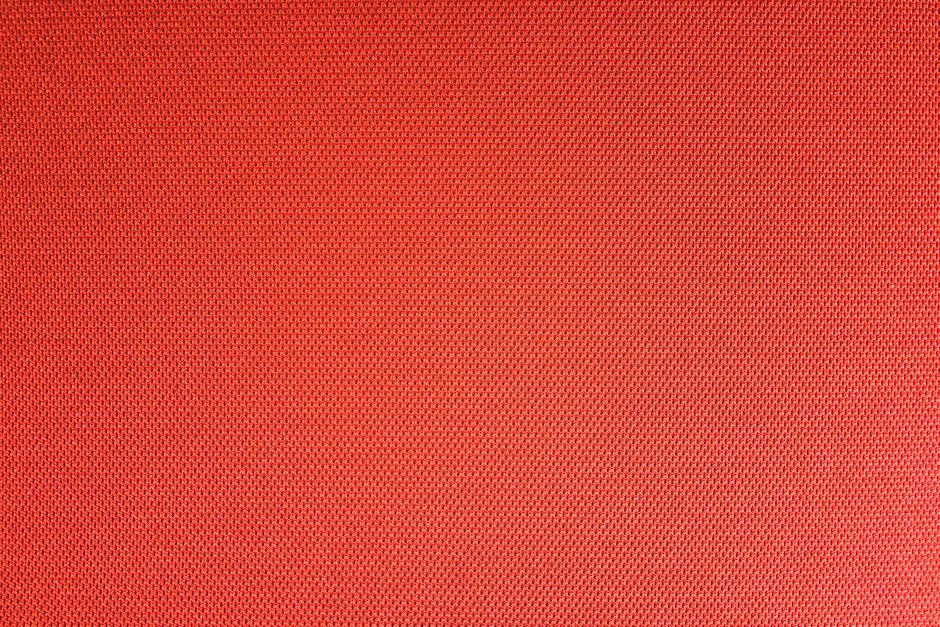 赩炽 — Top view of textured backdrop representing resistant bright red seamless textile with dry uneven surface