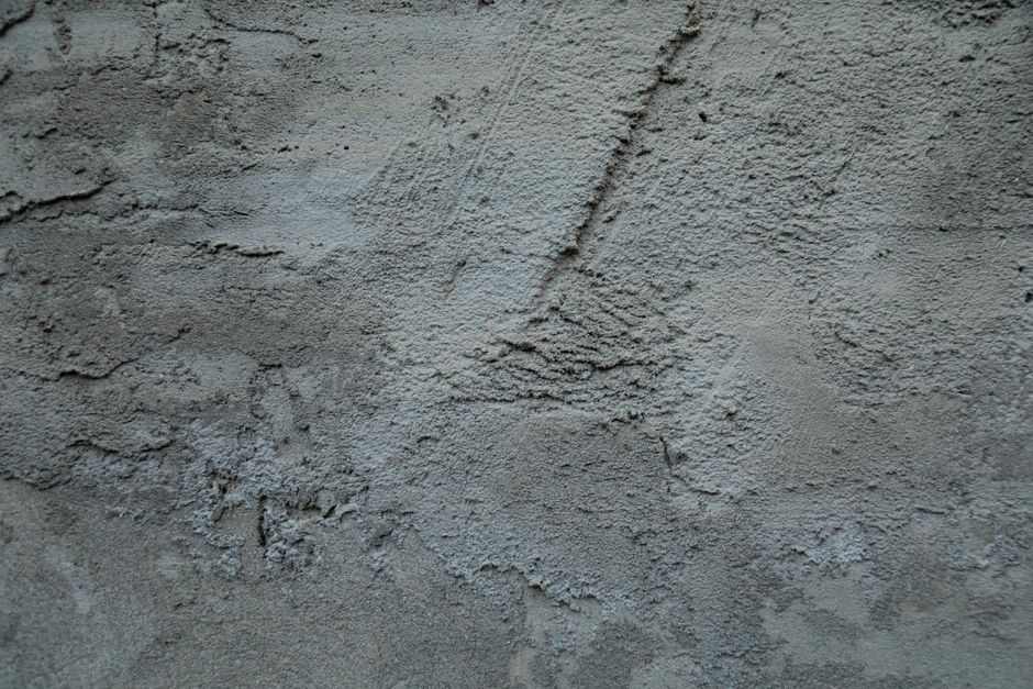 翕赩 — Detailed view of textured concrete wall with rough, rugged surface features.